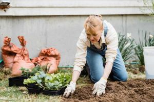 woman tending garden bed in summeer