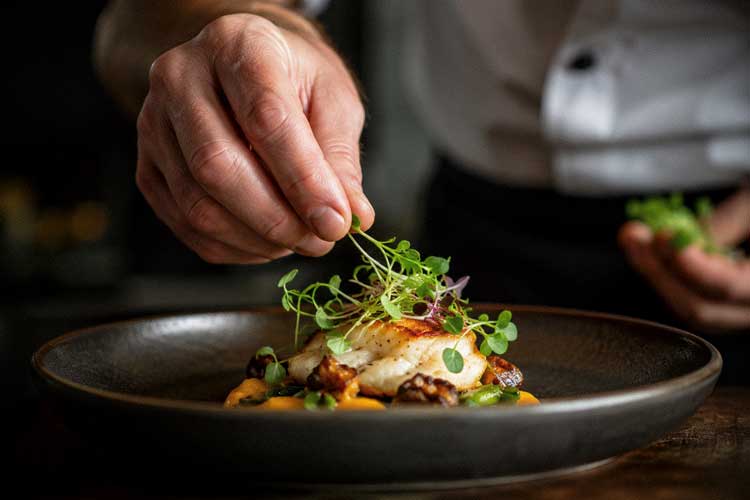 chef garnishing a plate